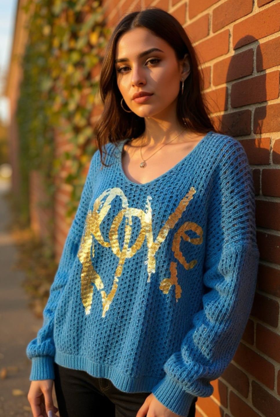 teal sweater with metallic gold print