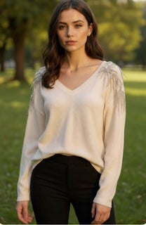 beige sweater with stones on shoulder