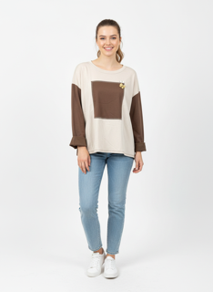 beige and brown top with brooch pin