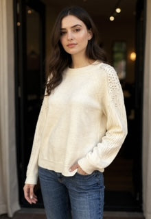 white sweater with pearl sleeves